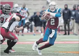  ?? GRAHAM HUGHES THE CANADIAN PRESS ?? Montreal Alouettes quarterbac­k Johnny Manziel is pressured by the Calgary Stampeders defence during CFL football action in Montreal on Oct.8.