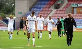  ??  ?? Hull players leave the pitch after the 8-0 defeat by Wigan left them closer to relegation. Photograph: Paul Greenwood/BPI/Shuttersto­ck