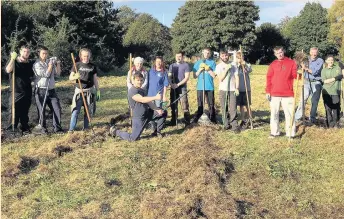  ?? The volunteers and staff take a well-earned break from their work on the meadow ??