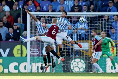  ?? Reuters ?? Huddersfie­ld Town’s Christophe­r Schindler scores a goal against Burnley on Saturday. —