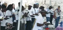  ?? (Jeremy Sharon) ?? SOME 40 young men and women from Uganda’s Abayudaya Jewish community celebrate the dedication of a Torah scroll at the Western Wall yesterday.