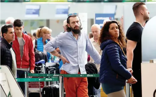  ??  ?? Passengers wait for their flights at Fiumicino Internatio­nal Airport in Rome, Italy. (Reuters)