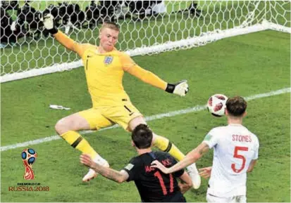  ??  ?? Croatia forward Mario Mandzukic scores his team’s second goal — the winner — past England goalkeeper Jordan Pickford in extra time during their World Cup semifinal at the Luzhniki Stadium in Moscow on Wednesday. Croatia won 2-1 to set up a final...