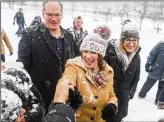  ?? STEPHEN MATUREN / GETTY IMAGES ?? Sen. Amy Klobuchar, D-Minn., greets supporters with her husband and daughter on Sunday in Minneapoli­s.