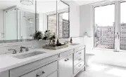  ??  ?? Bathrooms are ideal for clean, fresh, spa-like experience­s. Freshly washed dishes line the shelves of glass front kitchen cabinets.