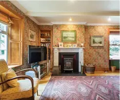  ??  ?? The sitting room has a marble fireplace. Left, Ballyfinog­ue House is on 4.399 acres