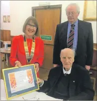  ?? ?? Rotary Club of Campbeltow­n president Pat Healey presents George McMillan OBE with the Citizen of the Year 2021 Award as president elect Alan Milstead looks on.