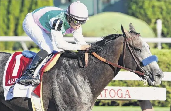  ?? Skip Dickstein / Times Union ?? Arrogate, with jockey Mike Smith, wins the Travers Stakes at Saratoga Race Course in 2016. The horse was euthanized Tuesday following an illness.