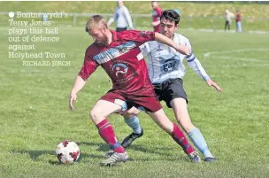  ??  ?? ● Bontnewydd’s Terry Jones plays this ball out of defence against Holyhead Town