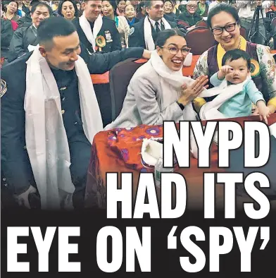  ??  ?? TROUBLE: Baimadajie Angwang (left) — the Tibetan NYPD officer who’s accused by the feds of spying for China — attends a Tibetan New Year party last year and hobnobs with Rep. Alexandria Ocasio-Cortez.