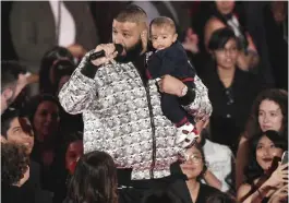  ??  ?? DJ Khaled speaks as he hold his son, Asahd.