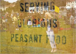  ?? Photos by Carlos Avila Gonzalez / The Chronicle ?? Far left: Ronnie and CherylWest­er of Amarillo, Texas, sample food from trucks at Off the Grid’s monthly Sunday event in he Presidio. A woman is reflected in a sign reading, “Serving Glorious Peasant Food,” during the Sunday Presidio event.