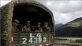  ?? REUTERS ?? Chinese soldiers of the People’s Liberation Army (PLA) sit on the back of a truck on the highway to Nyingchi, Tibet Autonomous Region, China, on 19 October 2020.