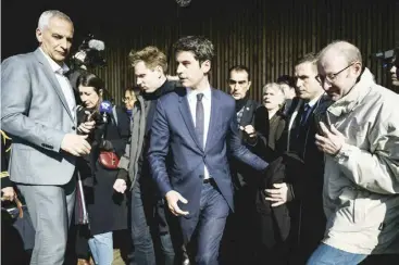  ?? JEFF PACHOUD/AGENCE FRANCE-PRESSE ?? FRENCH Prime Minister Gabriel Attal (center) leaves after attending a greetings ceremony from the mayor of Orlienas as part of his visit to the Rhone region, in Orlienas, central France.