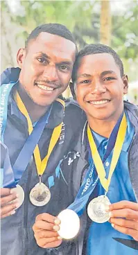  ?? Picture: SUPPLIED ?? Lulusago brothers ... Epeli and Josese show their silver medals in the teams Hobie 16 event at the Pacific Games sailing competitio­n.