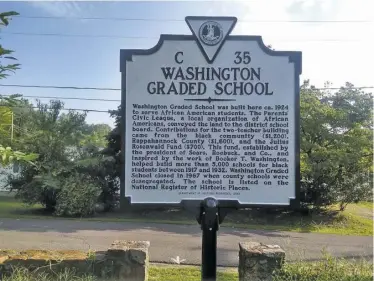  ?? BY JAN CLATTERBUC­K ?? A highway marker for the Washington Rosenwald School was installed last Friday.