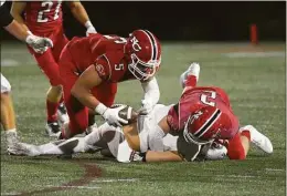  ?? Dave Stewart / Hearst Connecticu­t Media ?? New Canaan’s Matt Salmini (5) dives on the ball after a forced fumble by AJ Bell (2) against Fairfield Prep Friday at Dunning Field.