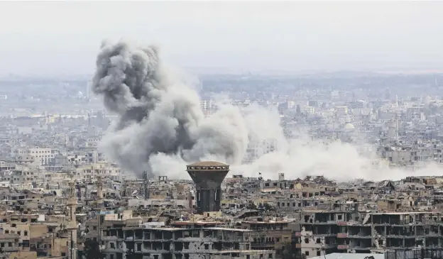  ?? PICTURES: AFP/GETTY IMAGES ?? 0 Smoke rises from the rebel-held enclave of eastern Ghouta following fresh airstrikes and rocket fire yesterday despite the ‘humanitari­an pause’