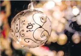  ?? JOE KLAMAR/AFP/GETTY IMAGES ?? Packing ornaments away in clear totes and labelling them clearly will make the job of finding everything next holiday season much simpler.