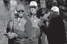  ?? CHRIS CARLSON/AP PHOTO ?? United States vice-captain Tiger Woods shares a laugh with Phil Mickelson, right, before a practice round for the Ryder Cup on Tuesday at Hazeltine National Golf Club in Chaska, Minn.