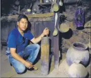  ??  ?? Amateur curator Ilyas Ansari with traditiona­l utensils, Museum of Memories, Hunderman Village