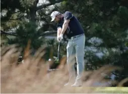  ?? CHARLES REX ARBOGAST/THE ASSOCIATED PRESS ?? Marc Leishman tees off at the fourth during third-round play at the BMW Championsh­ip on Saturday. He enters Sunday’s final round with a five-shot lead.