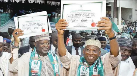  ??  ?? R-L: Governor Abdullahi Umar Ganduje of Kano State (right), and his Deputy, Dr. Nasiru Yusuf Gawun, displaying their certificat­es of return as governor-elect and deputy governor-elect, in Kano...yesterday