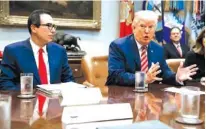  ?? THE ASSOCIATED PRESS ?? Treasury Secretary Steve Mnuchin listens as President Donald Trump speaks Tuesday during a meeting on tax policy with business leaders in the Roosevelt Room of the White House.