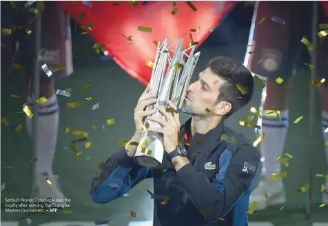  ?? — AFP ?? Serbia’s Novak Djokovic kisses the trophy after winning the Shanghai Masters tournament.