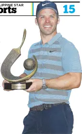  ??  ?? Paul Casey of England poses with the Valspar Championsh­ip trophy after winning at Innisbrook Resort Copperhead Course in Palm Harbor, Florida.