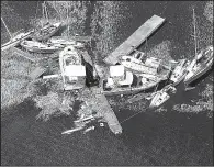  ?? AP/Atlanta Journal-Constituti­on/CURTIS COMPTON ?? Boats blown from their docks sit in the marsh Tuesday at St. Marys on the Georgia coast.