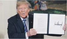  ?? EPA ?? Donald Trump holds up a national security memorandum on Iran after announcing the US would pull out of the deal