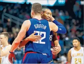  ?? Erik S. Lesser European Pressphoto Agency ?? THE CLIPPERS’ Blake Griffin and Wesley Johnson react during the closing seconds of a victory against Atlanta on Nov. 22. The win ended a nine-game skid.