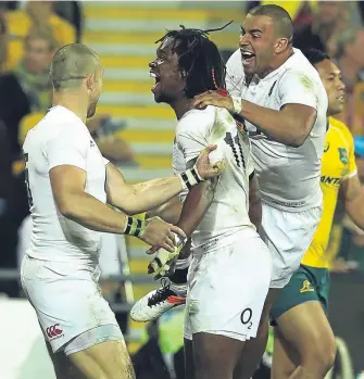  ??  ?? Marland Yarde (centre) celebrates with team-mates Jonathan Joseph and Mike Brown after scoring England’s second try yesterday.