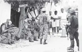  ?? JERMAINE BARNABY/PHOTOGRAPH­ER ?? Security forces on the ground in Mount Salem in Montego Bay, St James, within the zone of special operations on the weekend.