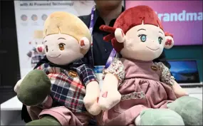  ?? ?? An employee of South Korean company Hyodol holds puppets meant to help elderly people during the MWC in Barcelona.