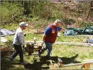  ?? Rebuilding Together / Contribute­d photo ?? Volunteers from Lowe’s in Torrington help to clean up the Kaminski yard.