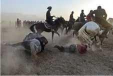  ?? ?? Horseman falling down during buzkashi.