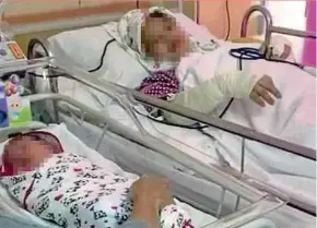  ??  ?? A teacher, who was stabbed by her husband on Friday, and her newborn son at Putrajaya Hospital on Saturday.