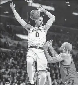  ?? Robert Gauthier Los Angeles Times ?? LAKERS FORWARD Kyle Kuzma, who finished with 18 points, dunks for two during the first quarter against the Houston Rockets.