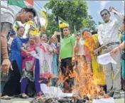  ?? AFP ?? GJM supporters burn copies of the GTA agreement during a protest in Dagapur village on the outskirts of Siliguri on Tuesday.