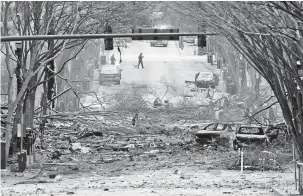  ?? MARK HUMPHREY/ASSOCIATED PRESS FILE PHOTO ?? Debris clogs a street after a Christmas Day explosion in Nashville, Tenn. The bombing caused damage to an AT&T facility, disrupting 911 call centers, hospitals and airline flights.