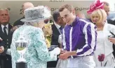  ??  ?? The Queen presents a medal to jockey Ryan Moore after his win on Merchant Navy. Picture: AP