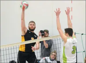  ?? NEWS PHOTO RYAN MCCRACKEN ?? Medicine Hat College Rattlers outside hitter Joel Kotyk hits a shot past Regan Fathers (3) of the Red Deer College Kings during Alberta Colleges Athletics Conference action Saturday at the Snake Pit.