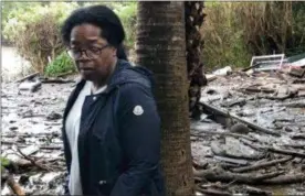  ?? OPRAH WINFREY VIA AP ?? Oprah Winfrey stands in debris and mud flow as she looks at her neighbors property in Montecito, Calif.