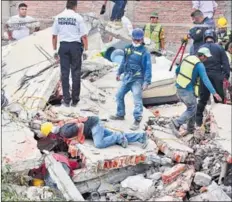  ?? AFP ?? Volunteers dig out people trapped under the mangled remains of a building.