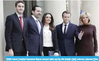  ??  ?? PARIS: French President Emmanuel Macron (second right) and his wife Brigitte (right) welcome Lebanese Prime Minister Saad Hariri, his wife Lara and their son Houssam at the Elysee Presidenti­al Palace yesterday. — AFP