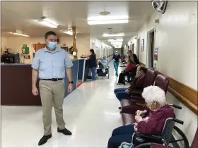  ?? DAVID A. LIEB — THE ASSOCIATED PRESS ?? Tim Corbin, left, the administra­tor of Truman Lake Manor, passes through the hallway of the nursing home on Feb. 14, 2023, in Lowry, Mo. The facility was cited in December for a violation of the federal vaccinatio­n requiremen­t for health care workers but subsequent­ly came into compliance. Corbin believes it’s time for the vaccinatio­n mandate to end.