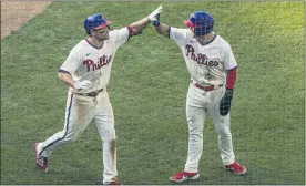  ?? ?? Philadelph­ia Phillies’ Phil Gosselin, left, celebrates his two-run home run with teammate Scott Kingery, right, during the sixth inning of a baseball game against the Miami Marlins Saturday in Philadelph­ia.