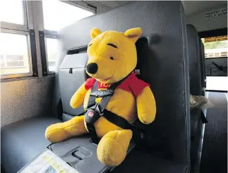  ?? DAVID BLOOM ?? A stuffed toy sits in a harness on a school bus during a learn to ride the bus event. The My First Ride and First Riders programs help students become comfortabl­e with bus riding before the first day of school.